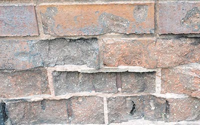 Spalling of a brick masonry wall caused by fire