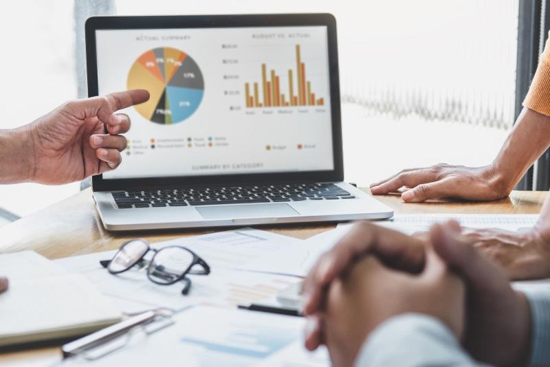 A business team looking at data on a laptop