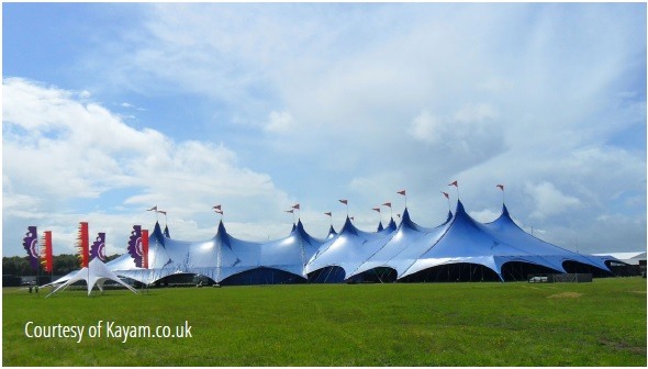 Kayam tent in a triangular layout that allows a proscenium stage for rock music.