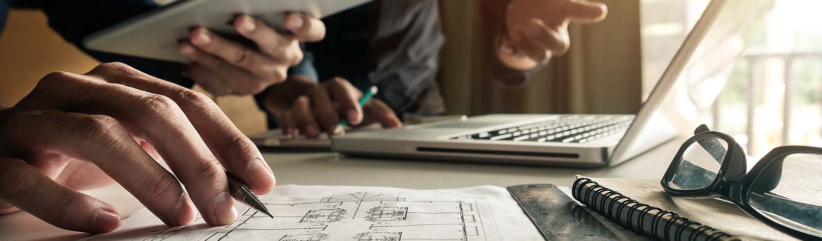 People planning, working together, view of hands and laptop on the table