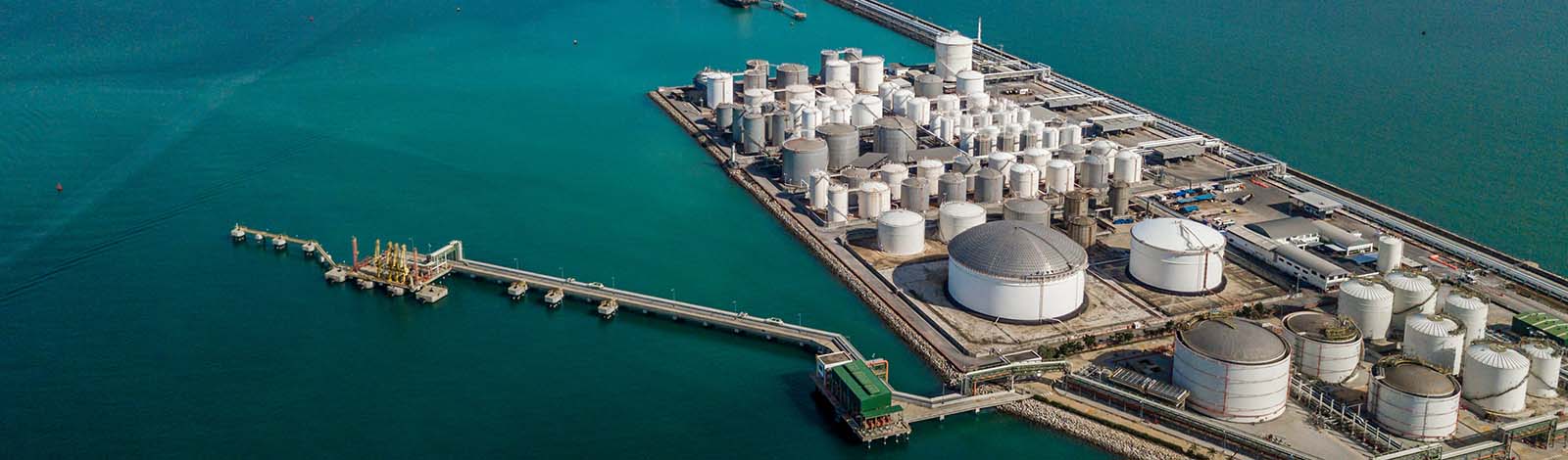 Aerial view of a tank farm, at the mouth to a harbour