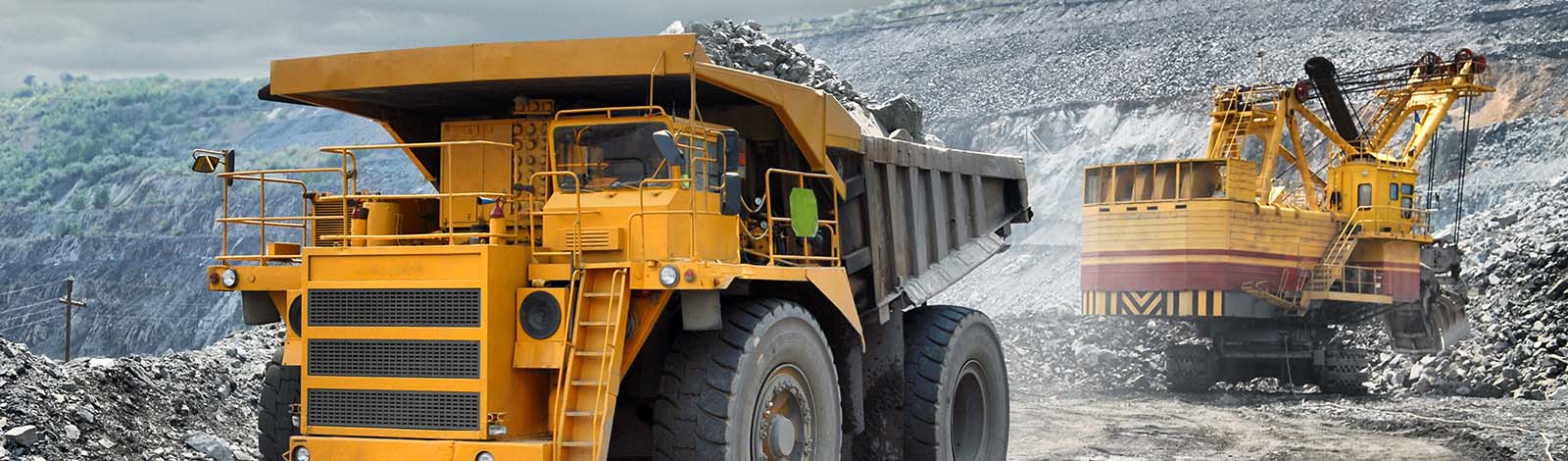 A view of big trucks, hauling resources from a coal mine