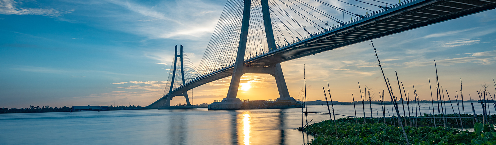 View of a bridge over a river, blue sky background