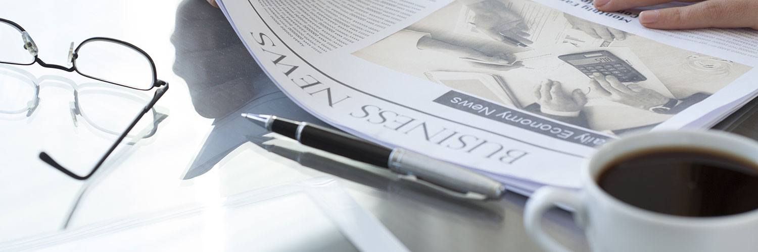 Newspaper and glasses on a desk