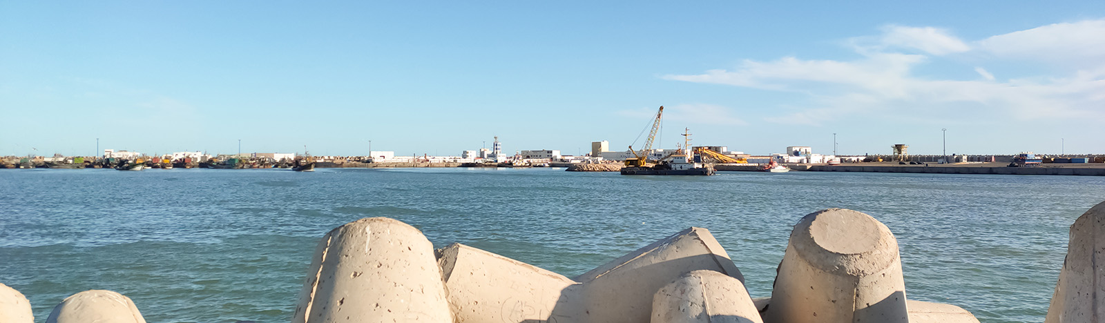 A view out to see across a port, with sea barriers in the foreground