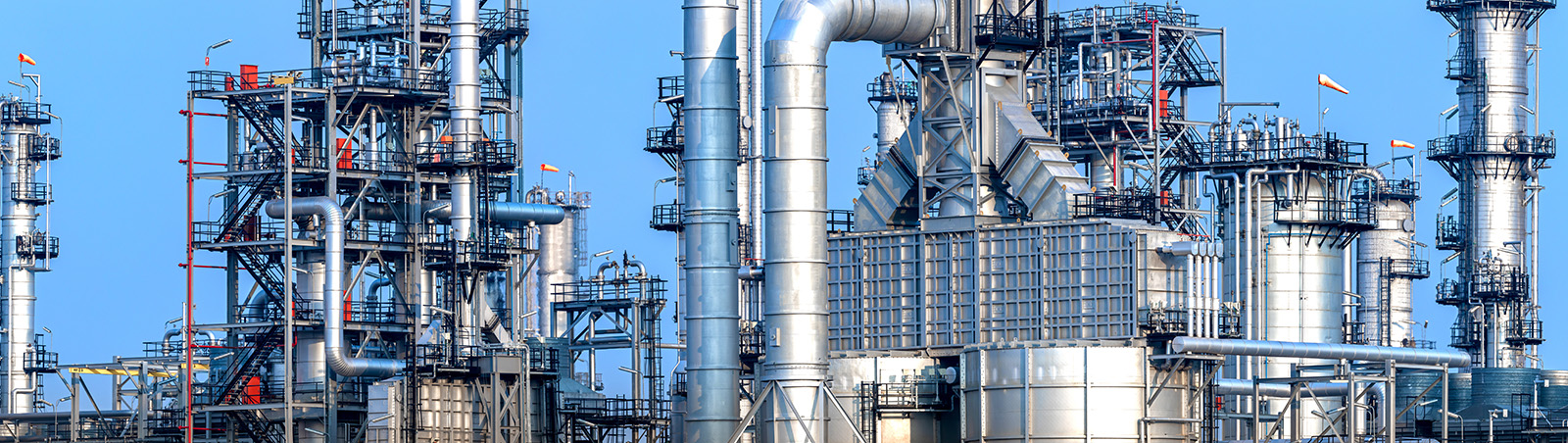 Oil refinery, against a blue sky